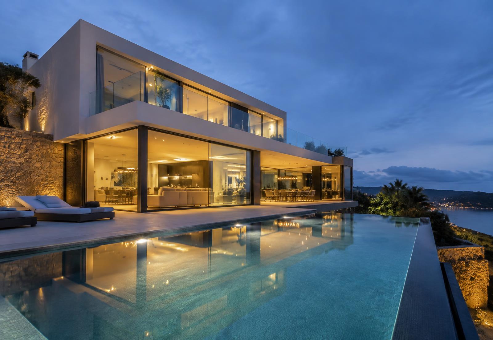 Modern villa with infinity pool at blue hour